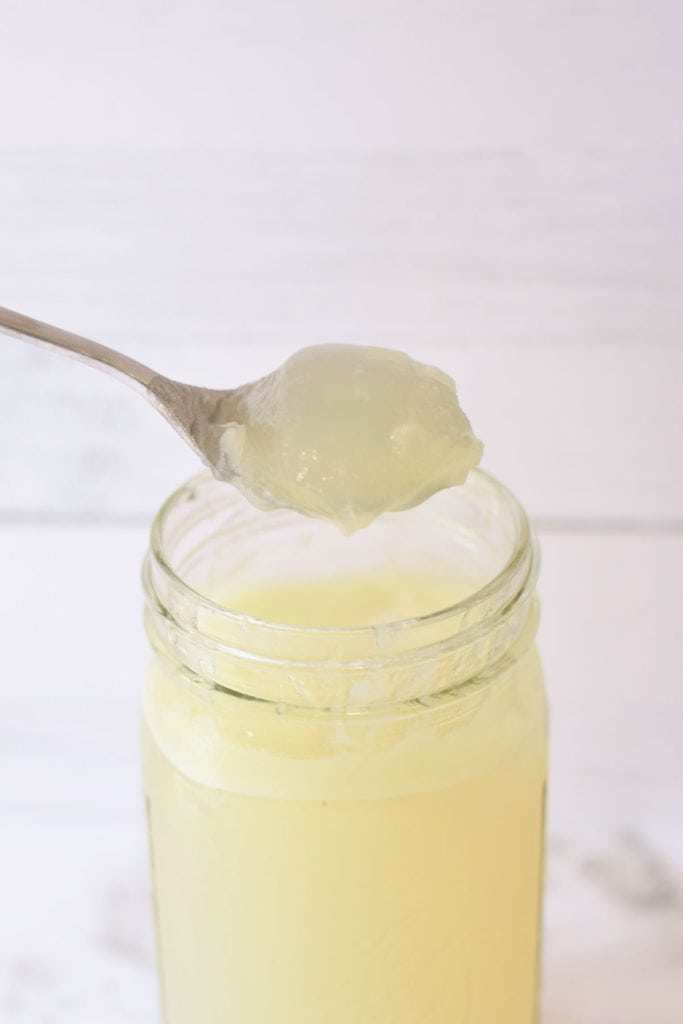 A spoon of gelatinous meat stock ready to be added to meal for kids and picky eaters.