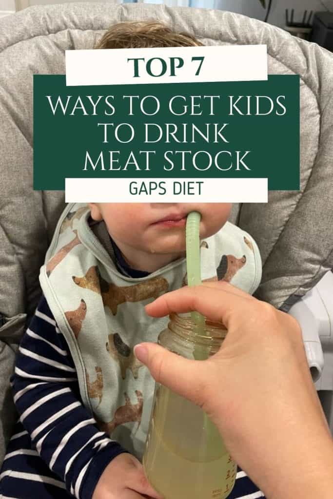 Parent offering a small mug of meat stock to a young child at the kitchen table