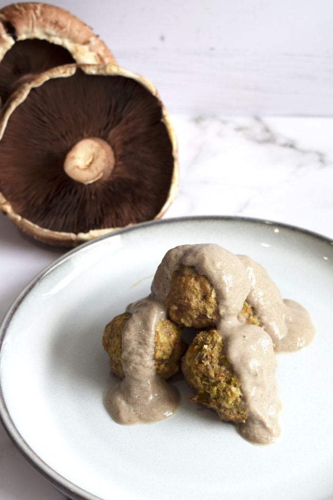 Plate of meat balls covered in mushroom sauce made with meat stock.